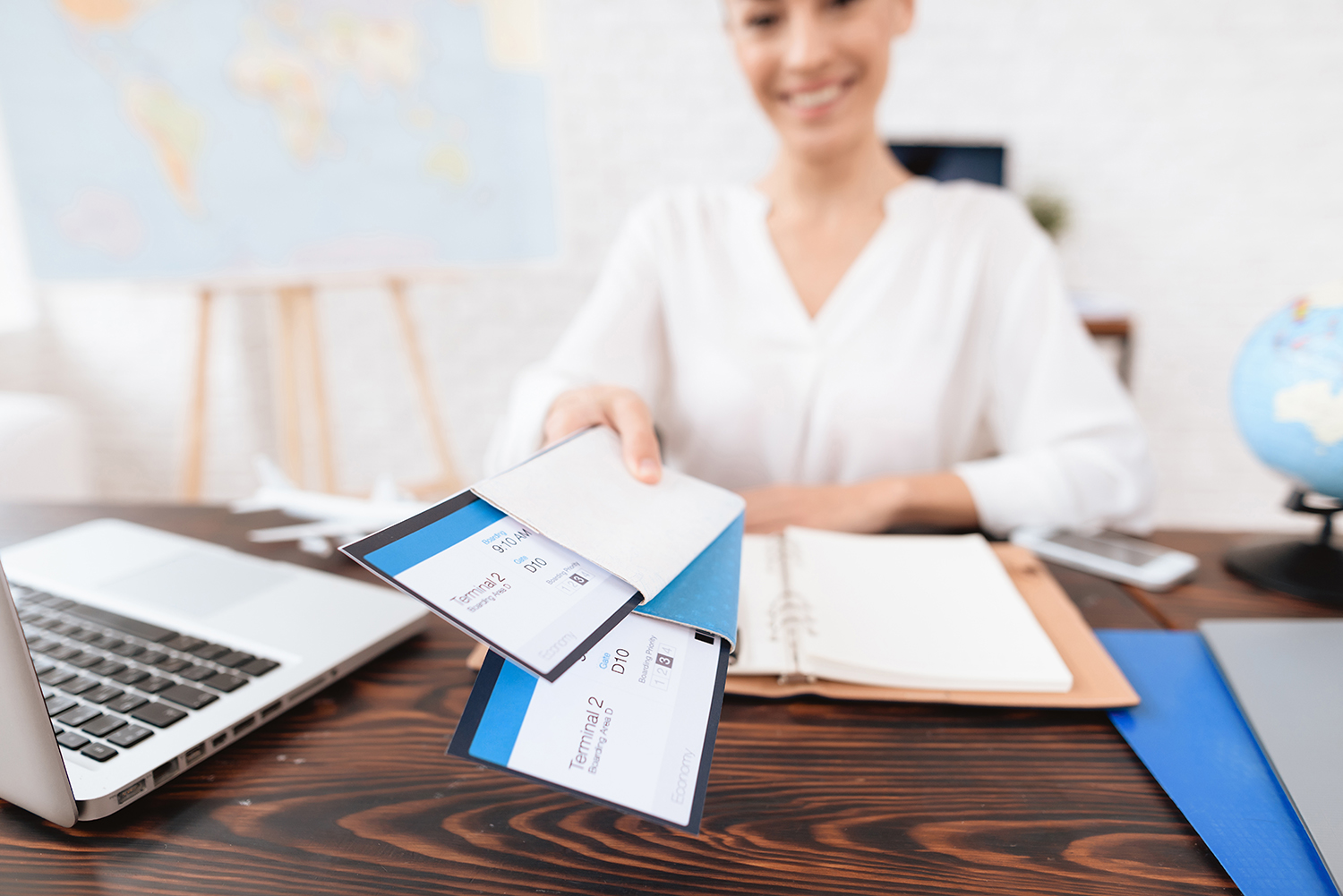 Travel agent keeps tickets for plane in the travel agency.